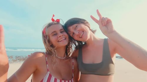 Two Happy Young Caucasian Women with Smile Posing Stand on Beach