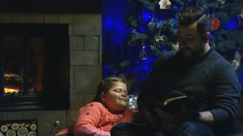 Man Reading to Girl by Fireplace at Christmas