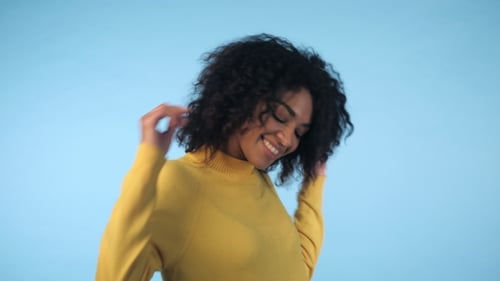 Young Woman Dancing with Curly Hair, Studio Portrait