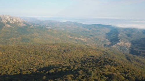 Aerial Shot of Beautiful Mountains Covered By Autumn Forest. Flight Above Mountains on Sunset