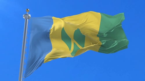 St. Vincent and the Grenadines Flag Waving Against Blue Sky