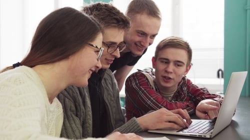 Group of Students Talking and Looking at Laptop Screen