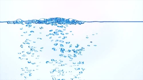 Ice Cubes Dropping into Clear Water with Bubbles