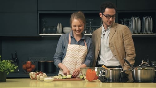 Couple Cooking and Sharing a Moment in Kitchen