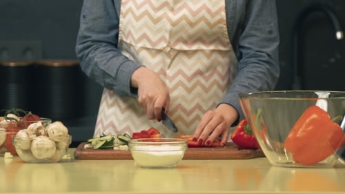 Woman Dicing Red Pepper in Kitchen for Cooking