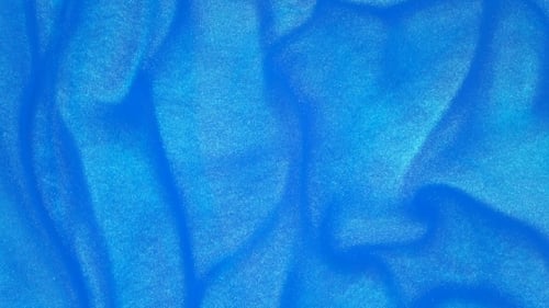 Footage. Ink in Water. Blue Ink Reacting in Water Creating Abstract Background.