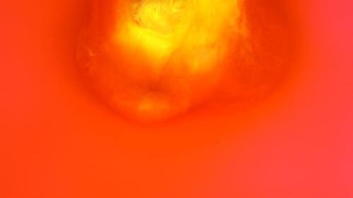 Yellow Paint Blending into Orange Liquid