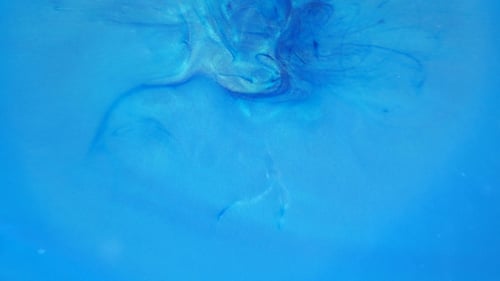 Tinta en agua. Tinta azul reaccionando en el agua creando un fondo abstracto.