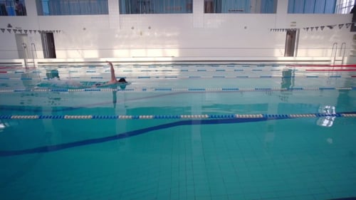 Male Athlete Swims in the Pool