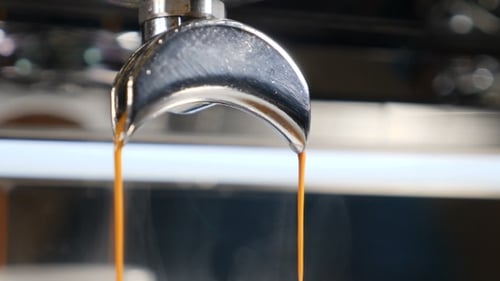 Espresso Pouring from Coffee Machine in Extreme Close Up