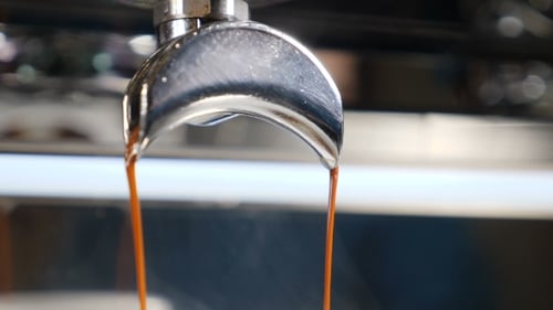Espresso Pouring From Coffee Machine Portafilter Close Up