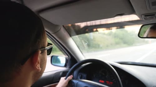 Unrecognizable Man in Sunglasses Driving Car on Highway