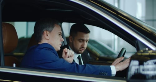 Men Discussing Car Interior in Dealership