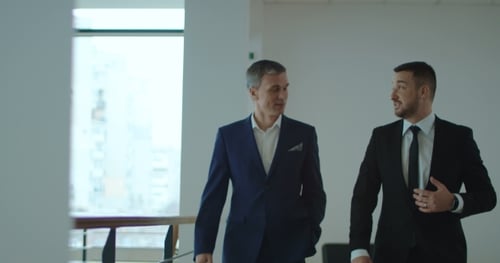 Businessmen Walking in Office