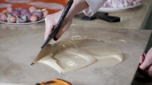 Spreading Melted White Chocolate with Spatula on Surface