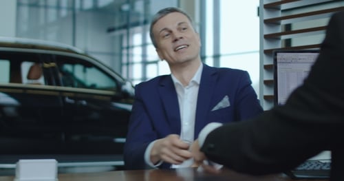 Buyer Signing Invoice Then Receiving New Car Key