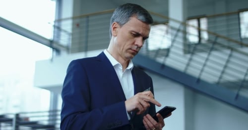 Businessman in Suit Using Phone