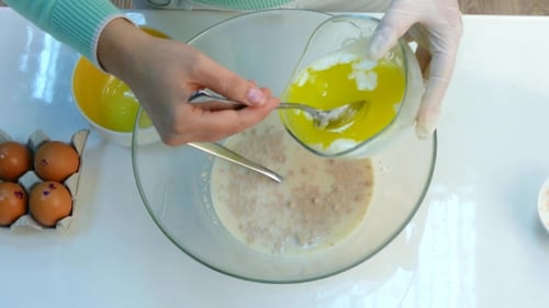 Adding Eggs to Bowl for Baking Recipe