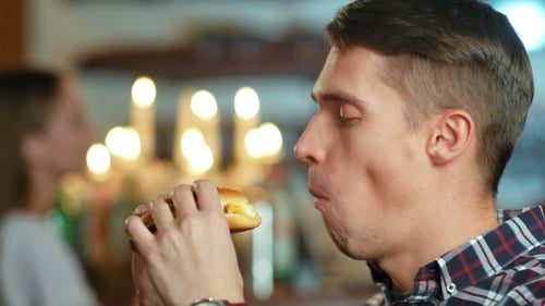 Man in a Restaurant Eating a Hamburger