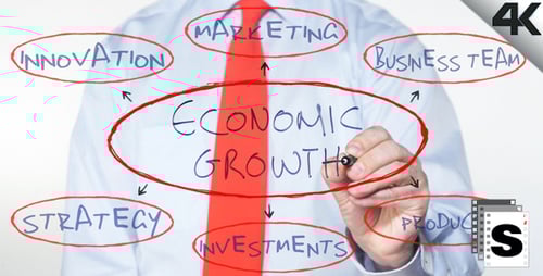 Man Writes Economic Growth on Glass Diagram