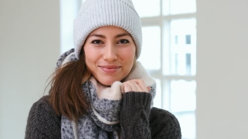 Smiling Woman Wearing Winter Scarf and Knit Hat
