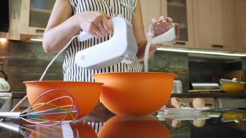 Woman Hand Pouring Sugar Into bowl.Mixing Ingredients for Cooking Cake