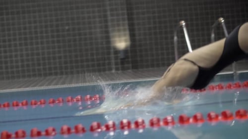 Woman Swimmer Jumping in Deep Water in Swimming Pool
