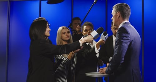 Businessman Cutting Off Interview with Reporters