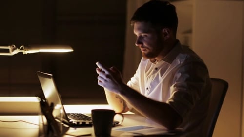 Man with Laptop and Smartphone at Night Office 88
