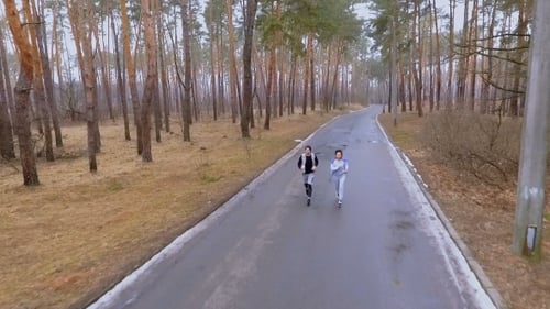 Young People Running in the Forest