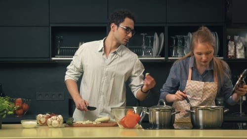 Couple Cooking Food Together in Modern Kitchen
