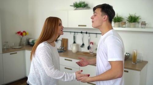 Upset Young Couple Arguing Passionately in a Kitchen