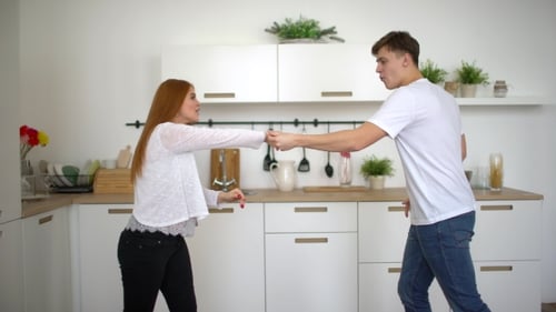 Young Couple Having Fun Dancing in the Kitchen