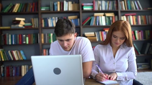 Man and Woman Studying Together with Laptop