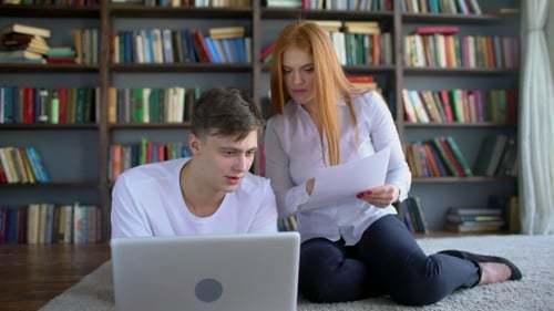 Male and Female Students Learning and Using Laptop in the Library. 4 k Two Students Brainstorming