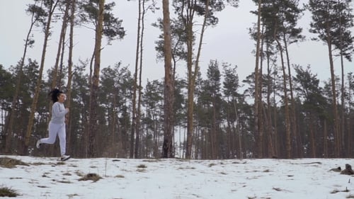 Young Girls Jumps Over the Stump During Jogging in the Forest