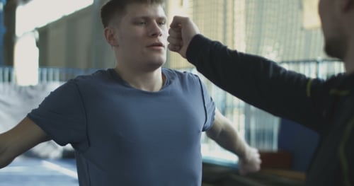Young Men Practice Martial Arts Hand and Arm Movements