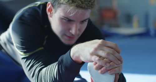 Sportsman Stretching in Gym