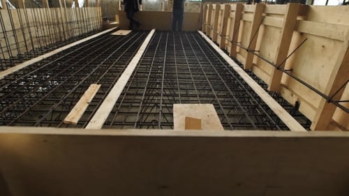 Laborers Are Standing and Walking over Reinforcing Cage Floor Slab in a Construction Site
