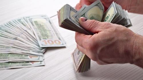 Close Up of Hands Counting American Dollars