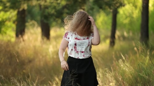 Young Woman Smiling in a Grassy Field