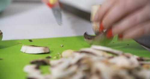 Woman Cutting Fresh Mushrooms on Cutting Board