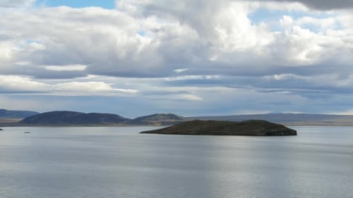 Amazing Tranquil Landscape in Blue Tones, with Lake, Sky and Low Clouds, Small Islands