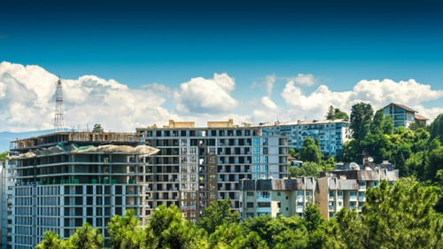 Building a House Surrounded by Trees and Clouds