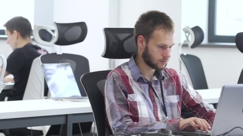 Man Works on Laptop in the Office