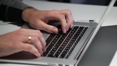 Man Types on the Laptop