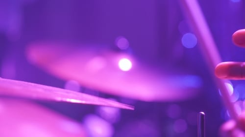 Musician Playing Drums During Rock Concert