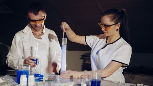 Two Chemists Examine Various Liquids in the Tubes. Experiments in the Laboratory