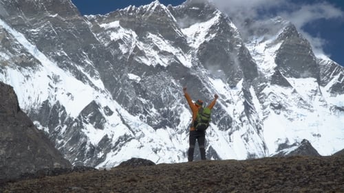Man with Backpack Climbs in the Himalayas