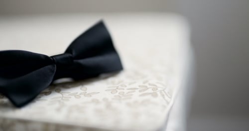 Black Bowtie on Table. Fashion Background.